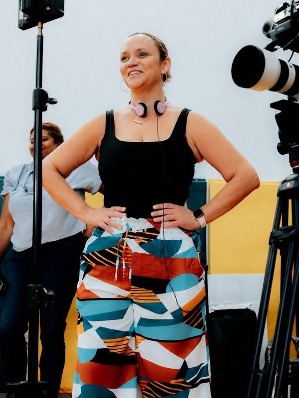 Sarah Jackson directing on set, headset around her neck
